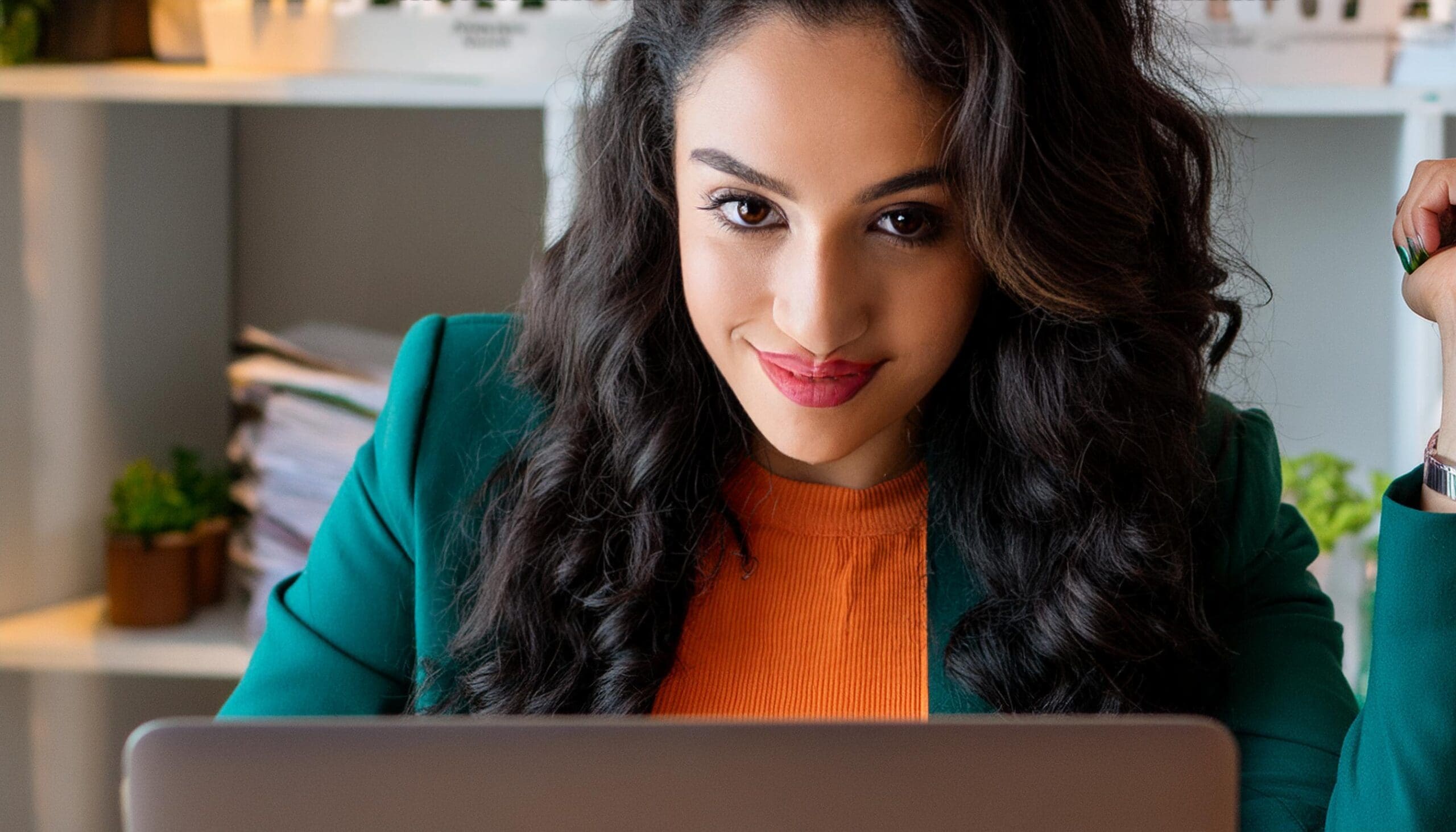 An event manager watching her registrations increase excitedly on her laptop because she leveraged event marketing automation to boost registration.